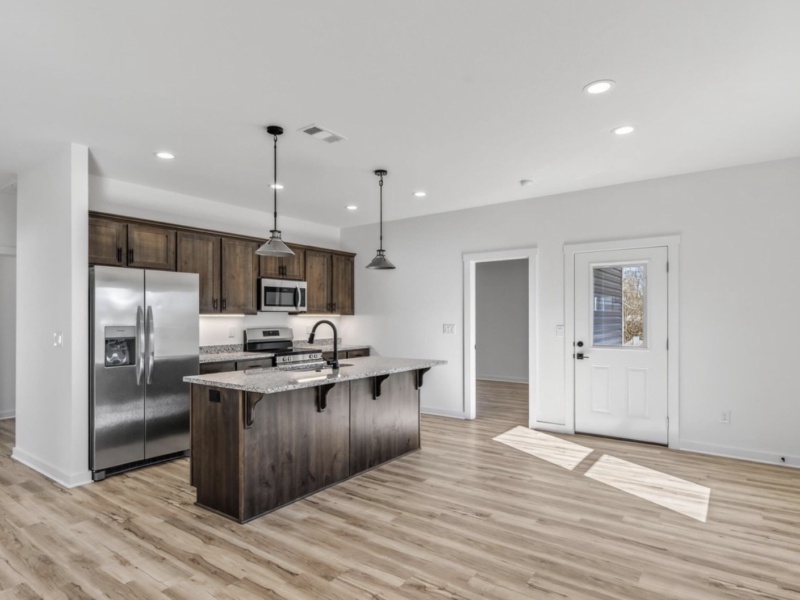 This brand new, move-in ready 3-bedroom, 2-bath home offers modern comfort with a stylish open-concept design. It features a kitchen with granite countertops, a spacious island, stainless steel appliances, and under-cabinet lighting. The two-car garage provides convenience and storage. Located conveniently near Joplin and Northwest Arkansas, it offers quick access to shopping, dining, and employment centers, all while being more affordable. This home is perfect for those seeking value, comfort, and convenience.